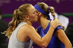 DOHA, QATAR - OCTOBER 28:  Caroline Wozniacki of Denmark kisses Victoria Azarenka of Belarus after her three set victory over her in their round robin match during the Sony Ericsson Championships at the Khalifa Tennis and Squash Complex on October 28, 2009 in Doha, Qatar.  (Photo by Clive Brunskill/Getty Images)
