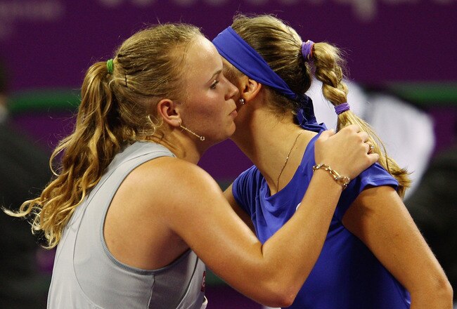 DOHA, QATAR - OCTOBER 28:  Caroline Wozniacki of Denmark kisses Victoria Azarenka of Belarus after her three set victory over her in their round robin match during the Sony Ericsson Championships at the Khalifa Tennis and Squash Complex on October 28, 2009 in Doha, Qatar.  (Photo by Clive Brunskill/Getty Images)