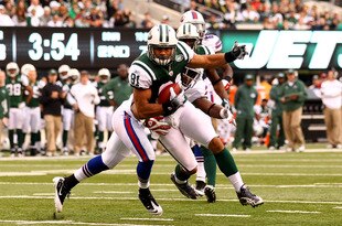 EAST RUTHERFORD, NJ - NOVEMBER 27:  Dustin Keller #81 of the New York Jets scores a touchdown as  Justin Rogers #26 of the Buffalo Bills is late with the tackle during their game on November 27, 2011 at  MetLife Stadium in East Rutherford, New Jersey.  (Photo by Al Bello/Getty Images)