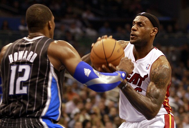 ORLANDO, FL - FEBRUARY 03:  Forward LeBron James #6 (R) of the Miami Heat drives against center Dwight Howard #12 of the Orlando Magic at Amway Arena on February 3, 2011 in Orlando, Florida. NOTE TO USER: User expressly acknowledges and agrees that, by downloading and or using this photograph, User is consenting to the terms and conditions of the Getty Images License Agreement. (Photo by Marc Serota/Getty Images)