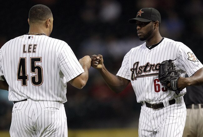 HOUSTON - SEPTEMBER 22:  Pitcher Henry Sosa #65 of the Houston Astros bumps fists with Carlos Lee #45 after Lee hit a three-run double in the third inning against the Colorado Rockie> at Minute Maid Park on September 22, 2011 in Houston, Texas.  (Photo by Bob Levey/Getty Images)