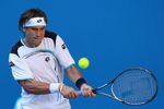 MELBOURNE, AUSTRALIA - JANUARY 23:  David Ferrer of Spain plays a backhand in his fourth round match against Richard Gasquet of France during day eight of the 2012 Australian Open at Melbourne Park on January 23, 2012 in Melbourne, Australia.  (Photo by Cameron Spencer/Getty Images)
