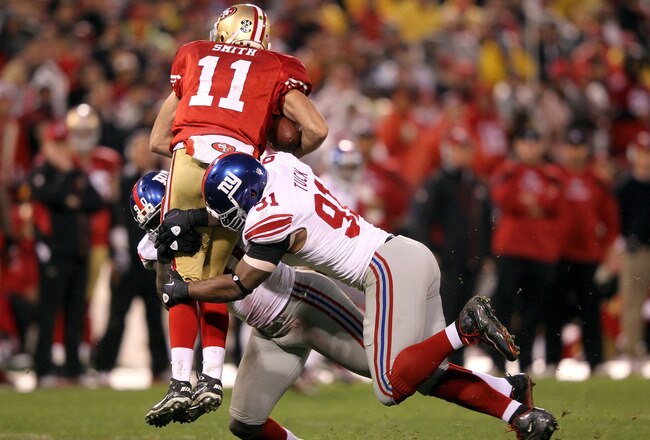 SAN FRANCISCO, CA - JANUARY 22:  Alex Smith #11 of the San Francisco 49ers is sacked by Justin Tuck #91 and Jason Pierre-Paul #90 of the New York Giants in the third quarter during the NFC Championship Game at Candlestick Park on January 22, 2012 in San Francisco, California.  (Photo by Jamie Squire/Getty Images)