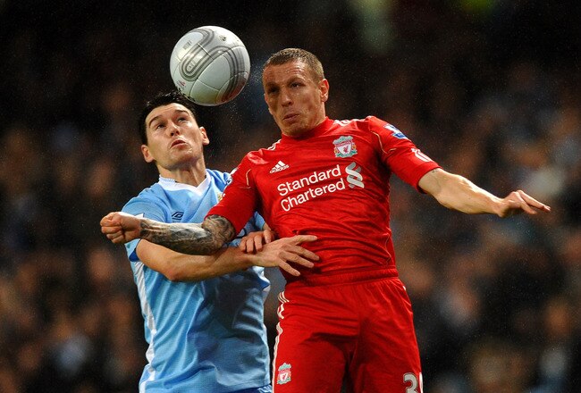 MANCHESTER, ENGLAND - JANUARY 11:  Craig Bellamy of Liverpool goes up for a header with Gareth Barry of Manchester City during the Carling Cup Semi Final First Leg match between Manchester City and Liverpool at the Etihad Stadium on January 11, 2012 in Manchester, England. (Photo by Laurence Griffiths/Getty Images)