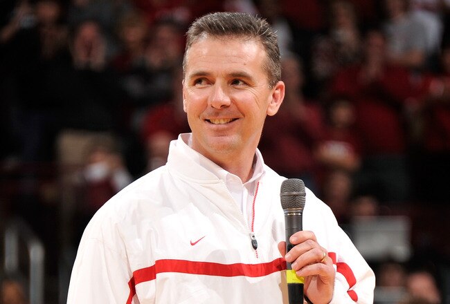 COLUMBUS, OH - JANUARY 15:  Head football coach Urban Meyer of the Ohio State Buckeyes is introduced to the crowd at halftime of the basketball game between the Indiana Hoosiers and the Ohio State Buckeyes on January 15, 2012 at Value City Arena in Columbus, Ohio.  (Photo by Jamie Sabau/Getty Images)