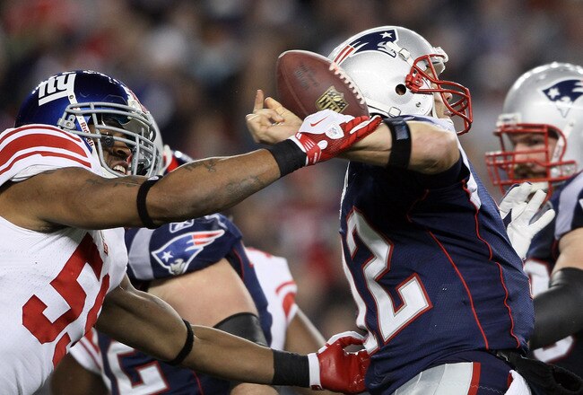FOXBORO, MA - NOVEMBER 06:   Michael Boley #59 of the New York Giants knocks the ball out of the hands of Tom Brady #12 of the New England Patriots  on November 6, 2011 at Gillette Stadium in Foxboro, Massachusetts.  (Photo by Elsa/Getty Images)