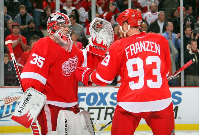 DETROIT, MI - JANUARY 23:  Johan Franzen #93 of the Detroit Red Wings celebrates a win over the St. Louis Blues with teammate Jimmy Howard #35 during their NHL game at Joe Louis Arena on January 23, 2012 in Detroit, Michigan.  (Photo by Dave Sandford/Getty Images)