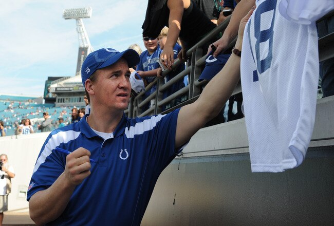 JACKSONVILLE, FL - JANUARY 01: Quarterback Peyton Manning #18 of the Indianapolis Colts signs autographs before the kickoff against the Jacksonville Jaguars January 1 at EverBank Field in Jacksonville, Florida.  (Photo by Al Messerschmidt/Getty Images)