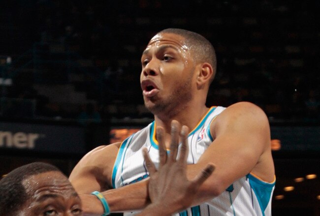 NEW ORLEANS, LA - JANUARY 04:  Eric Gordon #10 of the New Orleans Hornets passes the ball around Elton Brand #42 of the Philadelphia 76ers  at New Orleans Arena on January 4, 2012 in New Orleans, Louisiana.  NOTE TO USER: User expressly acknowledges and agrees that, by downloading and or using this photograph, User is consenting to the terms and conditions of the Getty Images License Agreement.  (Photo by Chris Graythen/Getty Images)