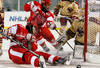 BOSTON - JANUARY 08:  Joe Pereira #6 and Luke Popko #26 of the Boston University Terriers try to get the puck past John Muse #1 of the Boston College Eagles on January 8, 2010 during the Sun Life Frozen Fenway Hockey Game at the Fenway Park in Boston, Massachusetts. The Terriers defeated the Eagles 3-2.  (Photo by Elsa/Getty Images)