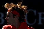 MELBOURNE, AUSTRALIA - JANUARY 24:  Roger Federer of Switzerland plays a backhand in his quarter final match against Juan Martin Del Potro of Argentina during day nine of the 2012 Australian Open at Melbourne Park on January 24, 2012 in Melbourne, Australia.  (Photo by Mark Dadswell/Getty Images)