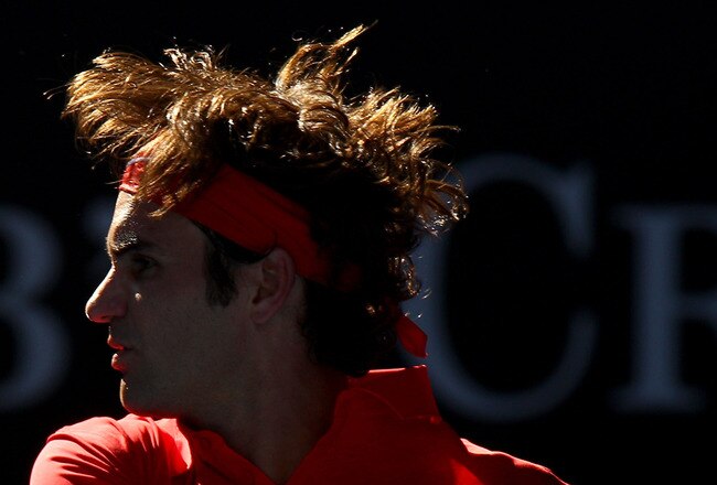 MELBOURNE, AUSTRALIA - JANUARY 24:  Roger Federer of Switzerland plays a backhand in his quarter final match against Juan Martin Del Potro of Argentina during day nine of the 2012 Australian Open at Melbourne Park on January 24, 2012 in Melbourne, Australia.  (Photo by Mark Dadswell/Getty Images)