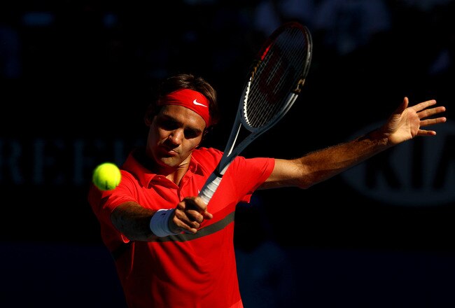 MELBOURNE, AUSTRALIA - JANUARY 24:  Roger Federer of Switzerland plays a backhand in his quarter final match against Juan Martin Del Potro of Argentina during day nine of the 2012 Australian Open at Melbourne Park on January 24, 2012 in Melbourne, Australia.  (Photo by Clive Brunskill/Getty Images)