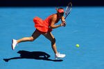 MELBOURNE, AUSTRALIA - JANUARY 24:  Caroline Wozniacki of Denmark plays a backhand in her quarter final match against Kim Clijsters of Belgium during day nine of the 2012 Australian Open at Melbourne Park on January 24, 2012 in Melbourne, Australia.  (Photo by Clive Brunskill/Getty Images)