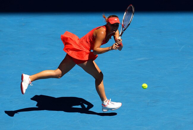 MELBOURNE, AUSTRALIA - JANUARY 24:  Caroline Wozniacki of Denmark plays a backhand in her quarter final match against Kim Clijsters of Belgium during day nine of the 2012 Australian Open at Melbourne Park on January 24, 2012 in Melbourne, Australia.  (Photo by Clive Brunskill/Getty Images)