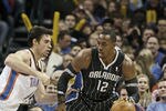 OKLAHOMA CITY, OK - DECEMBER 25:  Dwight Howard #12 of the Orlando Magic looks to drive on Nick Collison #4 of the Oklahoma City Thunder during the NBA season opening game December 25, 2011 at the Chesapeake Energy Arena in Oklahoma City, Oklahoma.  Oklahoma City defeated Orlando 97-89. NOTE TO USER: User expressly acknowledges and agrees that, by downloading and or using this Photograph, user is consenting to the terms and conditions of the Getty Images License Agreement.  (Photo by Brett Deering/Getty Images)