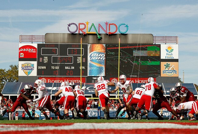 ORLANDO, FL - JANUARY 02: Taylor Martinez #3 hands off to Rex Burkhead #22of the Nebraska Cornhuskers during the Capitol One Bowl against the South Carolina Gamecocks at Florida Citrus Bowl on January 2, 2012 in Orlando, Florida.  (Photo by Mike Ehrmann/Getty Images)
