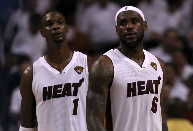 MIAMI, FL - JUNE 12:  (L-R) Chris Bosh #1 and LeBron James #6 of the Miami Heat look on against the Dallas Mavericks in Game Six of the 2011 NBA Finals at American Airlines Arena on June 12, 2011 in Miami, Florida. NOTE TO USER: User expressly acknowledges and agrees that, by downloading and/or using this Photograph, user is consenting to the terms and conditions of the Getty Images License Agreement.  (Photo by Ronald Martinez/Getty Images)
