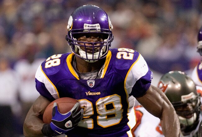 MINNEAPOLIS, MN - SEPTEMBER 18: Adrian Peterson #28 of the Minnesota Vikings avoids a tackle by Cody Grimm #35 of the Tampa Bay Buccaneers in the second quarter on September 18, 2011 at Hubert H. Humphrey Metrodome in Minneapolis, Minnesota. Peterson scored on the play. (Photo by Hannah Foslien/Getty Images)