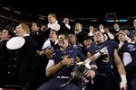 LANDOVER, MD - DECEMBER 10:  Kriss Proctor #2 and John Howell #33 (R) of the Navy Midshipmen celebrate their 27-21 win over the Army Black Knights at FedEx Field on December 10, 2011 in Landover, Maryland.  (Photo by Rob Carr/Getty Images)