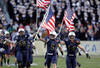 LANDOVER, MD - DECEMBER 10:  John Dowd #68, Brian Blick #5, and Max Blue #44 of the Navy Midshipmen carry the American flags onto the field before the start of the 112th annual Army-Navy Game of the Navy Midshipmen  at FedEx Field on December 10, 2011 in Landover, Maryland.  (Photo by Rob Carr/Getty Images)