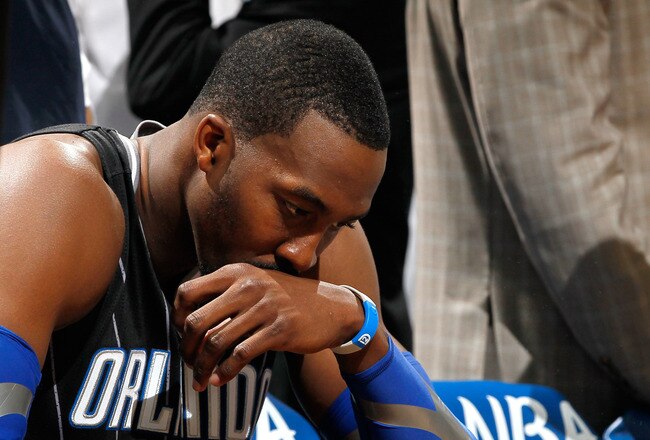 ATLANTA, GA - APRIL 28:  Dwight Howard #12 of the Orlando Magic sits on the bench during a timeout before the final seconds against the Atlanta Hawks during Game Six of the Eastern Conference Quarterfinals in the 2011 NBA Playoffs at Philips Arena on April 28, 2011 in Atlanta, Georgia.  NOTE TO USER: User expressly acknowledges and agrees that, by downloading and or using this photograph, User is consenting to the terms and conditions of the Getty Images License Agreement.  (Photo by Kevin C. Cox/Getty Images)