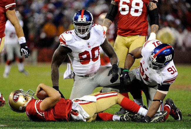 SAN FRANCISCO, CA - JANUARY 22:  Jason Pierre-Paul #90 and Justin Tuck #91 of the New York Giants react afetr they sacked Alex Smith #11 of the San Francisco 49ers in the second half during the NFC Championship Game at Candlestick Park on January 22, 2012 in San Francisco, California.  (Photo by Thearon W. Henderson/Getty Images)