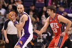PHOENIX, AZ - JANUARY 13:  Marcin Gortat #4 of the Phoenix Suns handles the ball during the NBA game against the New Jersey Nets at US Airways Center on January 13, 2012 in Phoenix, Arizona. The Nets defeated the Suns 110-103.   NOTE TO USER: User expressly acknowledges and agrees that, by downloading and or using this photograph, User is consenting to the terms and conditions of the Getty Images License Agreement.  (Photo by Christian Petersen/Getty Images)