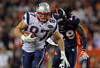 DENVER, CO - DECEMBER 18:  Tight end Rob Gronkowski #87 of the New England Patriots runs with the ball against free safety Quinton Carter #28 the Denver Broncos at Sports Authority Field at Mile High on December 18, 2011 in Denver, Colorado.  (Photo by Doug Pensinger/Getty Images)