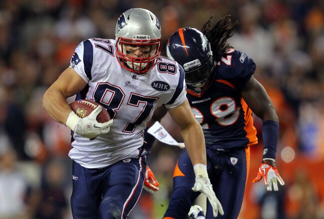 DENVER, CO - DECEMBER 18:  Tight end Rob Gronkowski #87 of the New England Patriots runs with the ball against free safety Quinton Carter #28 the Denver Broncos at Sports Authority Field at Mile High on December 18, 2011 in Denver, Colorado.  (Photo by Doug Pensinger/Getty Images)