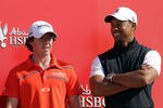 ABU DHABI, UNITED ARAB EMIRATES - JANUARY 24:  Rory McIlroy of Northern Ireland (L) chats to Tiger Woods of the USA during a preview photocall for the 2012 Abu Dhabi HSBC Golf Championship at the Abu Dhabi Golf Club on January 24, 2012 in Abu Dhabi, United Arab Emirates.  (Photo by Ross Kinnaird/Getty Images)