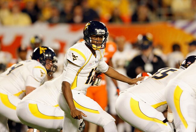 MIAMI GARDENS, FL - JANUARY 04:  Geno Smith #12 of the West Virginia Mountaineers calls signals out as he steps up to the line against the Clemson Tigers during the Discover Orange Bowl at Sun Life Stadium on January 4, 2012 in Miami Gardens, Florida.  (Photo by Mike Ehrmann/Getty Images)