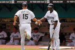MIAMI GARDENS, FL - SEPTEMBER 04:  Gaby Sanchez #15 of the Florida Marlins is congratulated by Mike Cameron #24 after scoring during a game against the Philadelphia Phillies at Sun Life Stadium on September 4, 2011 in Miami Gardens, Florida.  (Photo by Mike Ehrmann/Getty Images)