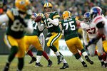 GREEN BAY, WI - JANUARY 15:  Aaron Rodgers #12 of the Green Bay Packers looks to pass against the New York Giants during their NFC Divisional playoff game at Lambeau Field on January 15, 2012 in Green Bay, Wisconsin.  (Photo by Jamie Squire/Getty Images)