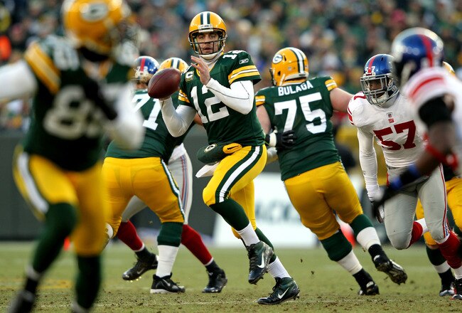 GREEN BAY, WI - JANUARY 15:  Aaron Rodgers #12 of the Green Bay Packers looks to pass against the New York Giants during their NFC Divisional playoff game at Lambeau Field on January 15, 2012 in Green Bay, Wisconsin.  (Photo by Jamie Squire/Getty Images)
