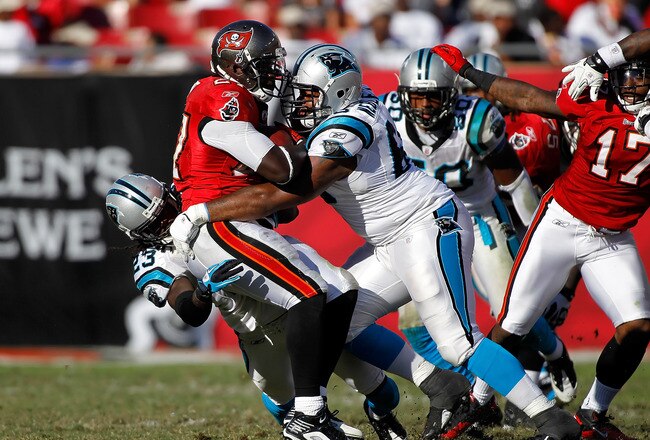 TAMPA, FL - NOVEMBER 14:  Defenders Andre Neblett #68 and Sherrod Martin #23 of the Carolina Panthers tackle running back LeGarrette Blount #27 of the Tampa Bay Buccaneers during the game at Raymond James Stadium on November 14, 2010 in Tampa, Florida.  (Photo by J. Meric/Getty Images)