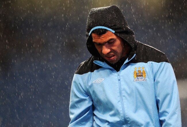 MANCHESTER, ENGLAND - SEPTEMBER 21: Carlos Tevez of Manchester City warms up in the rain before the Carling Cup Third Round match between Manchester City and Birmingham City at the Etihad Stadium on September 21, 2011 in Manchester, England.  (Photo by Michael Regan/Getty Images)