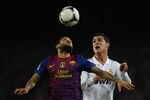 BARCELONA, SPAIN - JANUARY 25: Dani Alves of FC Barcelona (L) duels for a high ball with Cristiano Ronaldo of Real Madrid  during the Copa del Rey quarter final second leg match between FC Barcelona and Real Madrid at Camp Nou on January 25, 2012 in Barcelona, Spain.  (Photo by David Ramos/Getty Images)