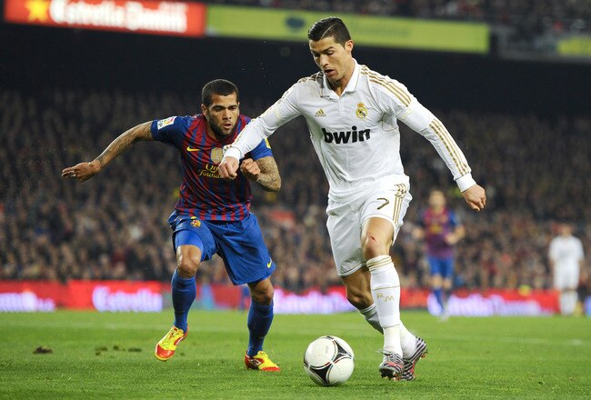 BARCELONA, SPAIN - JANUARY 25:  Cristiano Ronaldo of Real Madrid (R) duels for the ball with Dani Alves of FC Barcelona during the Copa del Rey quarter final second leg match between FC Barcelona and Real Madrid at Camp Nou on January 25, 2012 in Barcelona, Spain.  (Photo by David Ramos/Getty Images)