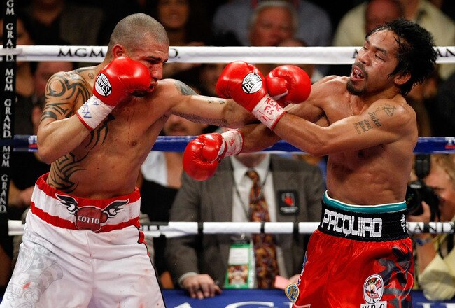 LAS VEGAS - NOVEMBER 14:  (L-R) Miguel Cotto of Puerto Rico throws a left to the head of Manny Pacquiao during their WBO welterweight title fight at the MGM Grand Garden Arena on November 14, 2009 in Las Vegas, Nevada. Pacquiao defeated Cotto by 12th round TKO.  (Photo by Ethan Miller/Getty Images)