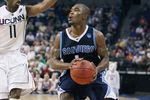 TAMPA, FL - MARCH 21: Brandon Johnson #1 of the San Diego Toreros brings the ball up court as he is guarded by Jermone Dyson #11 of the Connecticut Huskies during the first round of the 2008 NCAA Tournament West Regional at the St. Pete Times Forum on March 21, 2008 in Tampa, Florida. (Photo by Doug Benc/Getty Images)
