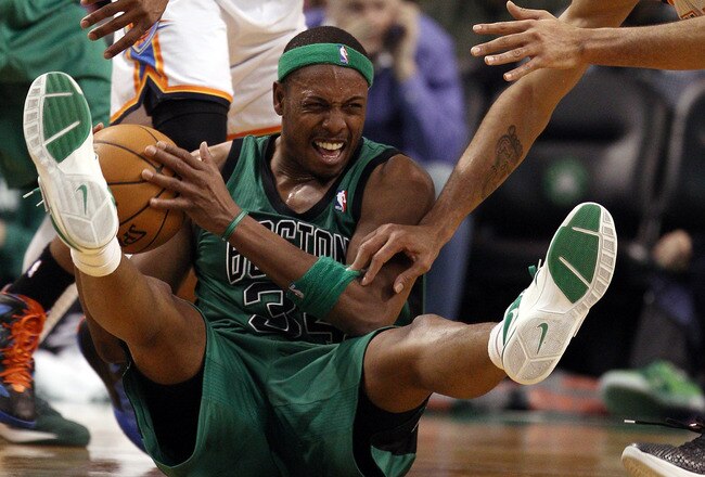BOSTON, MA - JANUARY 16:  Paul Pierce #34 of the Boston Celtics tries to hang on to the ball as Thabo Sefolosha #2 and Russell Westbrook #0 of the Oklahoma City Thunder defend on January 16, 2012 at TD Garden in Boston, Massachusetts. The Oklahoma City Thunder defeated the Boston Celtics 97-88. NOTE TO USER: User expressly acknowledges and agrees that, by downloading and or using this photograph, User is consenting to the terms and conditions of the Getty Images License Agreement.  (Photo by Elsa/Getty Images)