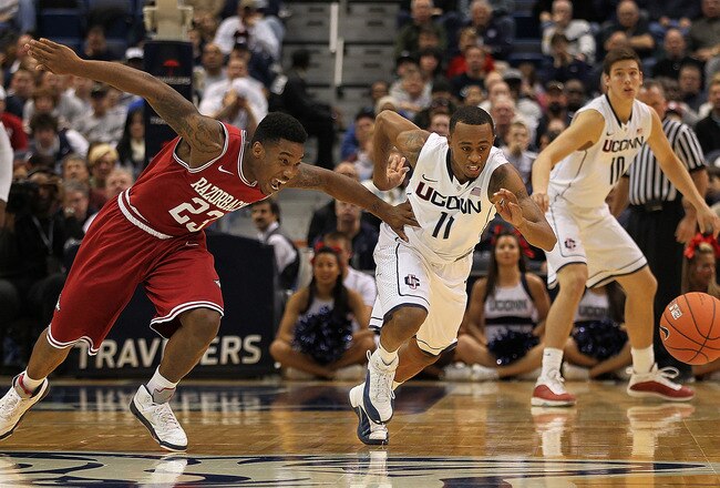 HARTFORD, CT - DECEMBER 3:  Ryan Boatright #11 of the Connecticut Huskies chases a loose ball against Julysses Nobles #23 of the Arkansas Razorbacks in the first half on December 3, 2011 at the XL Center in Hartford, Connecticut.  (Photo by Jim Rogash/Getty Images)