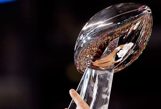 ARLINGTON, TX - FEBRUARY 06:  Quarterback Aaron Rodgers #12 of the Green Bay Packers holds up the VInce Lombardi trophy after the Packers won 31-25 against the Pittsburgh Steelers during Super Bowl XLV at Cowboys Stadium on February 6, 2011 in Arlington, Texas.  (Photo by Kevin C. Cox/Getty Images)