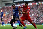 LIVERPOOL, ENGLAND - OCTOBER 15:  Luis Suarez of Liverpool tussles for posesssion with Patrice Evra of Manchester United during the Barclays Premier League match between Liverpool and Manchester United at Anfield on October 15, 2011 in Liverpool, England.  (Photo by Clive Brunskill/Getty Images)
