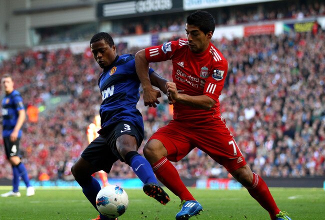 LIVERPOOL, ENGLAND - OCTOBER 15:  Luis Suarez of Liverpool tussles for posesssion with Patrice Evra of Manchester United during the Barclays Premier League match between Liverpool and Manchester United at Anfield on October 15, 2011 in Liverpool, England.  (Photo by Clive Brunskill/Getty Images)