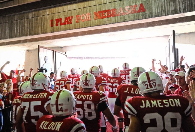 LINCOLN, NE - OCTOBER 16: The Nebraska Cornuskers run through a gauntlet of fans as they take the field against the Texas Longhorns at Memorial Stadium on October 16, 2010 in Lincoln, Nebraska. Texas Defeated Nebraska 20-13. (Photo by Eric Francis/Getty Images)