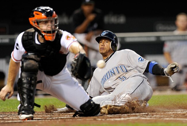 BALTIMORE, MD - AUGUST 31:  Yunel Escobar #5 of the Toronto Blue Jays slides into home plate ahead of the throw to catcher Craig Tatum #15 of the Baltimore Orioles in the third inning at Oriole Park at Camden Yards on August 31, 2011 in Baltimore, Maryland.  (Photo by Greg Fiume/Getty Images)