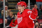 DETROIT, MI - OCTOBER 28: Pavel Datsyuk #13 of the Detroit Red Wings celebrates a second-period assist on a goal by teammate Tomas Holmstrom #96 while playing the San Jose Sharks at Joe Louis Arena on October 28, 2011 in Detroit, Michigan. San Jose won the game 4-2. (Photo by Gregory Shamus/Getty Images)