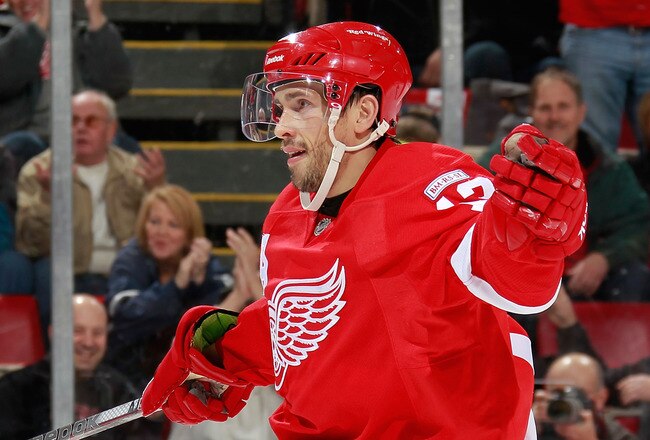 DETROIT, MI - OCTOBER 28: Pavel Datsyuk #13 of the Detroit Red Wings celebrates a second-period assist on a goal by teammate Tomas Holmstrom #96 while playing the San Jose Sharks at Joe Louis Arena on October 28, 2011 in Detroit, Michigan. San Jose won the game 4-2. (Photo by Gregory Shamus/Getty Images)